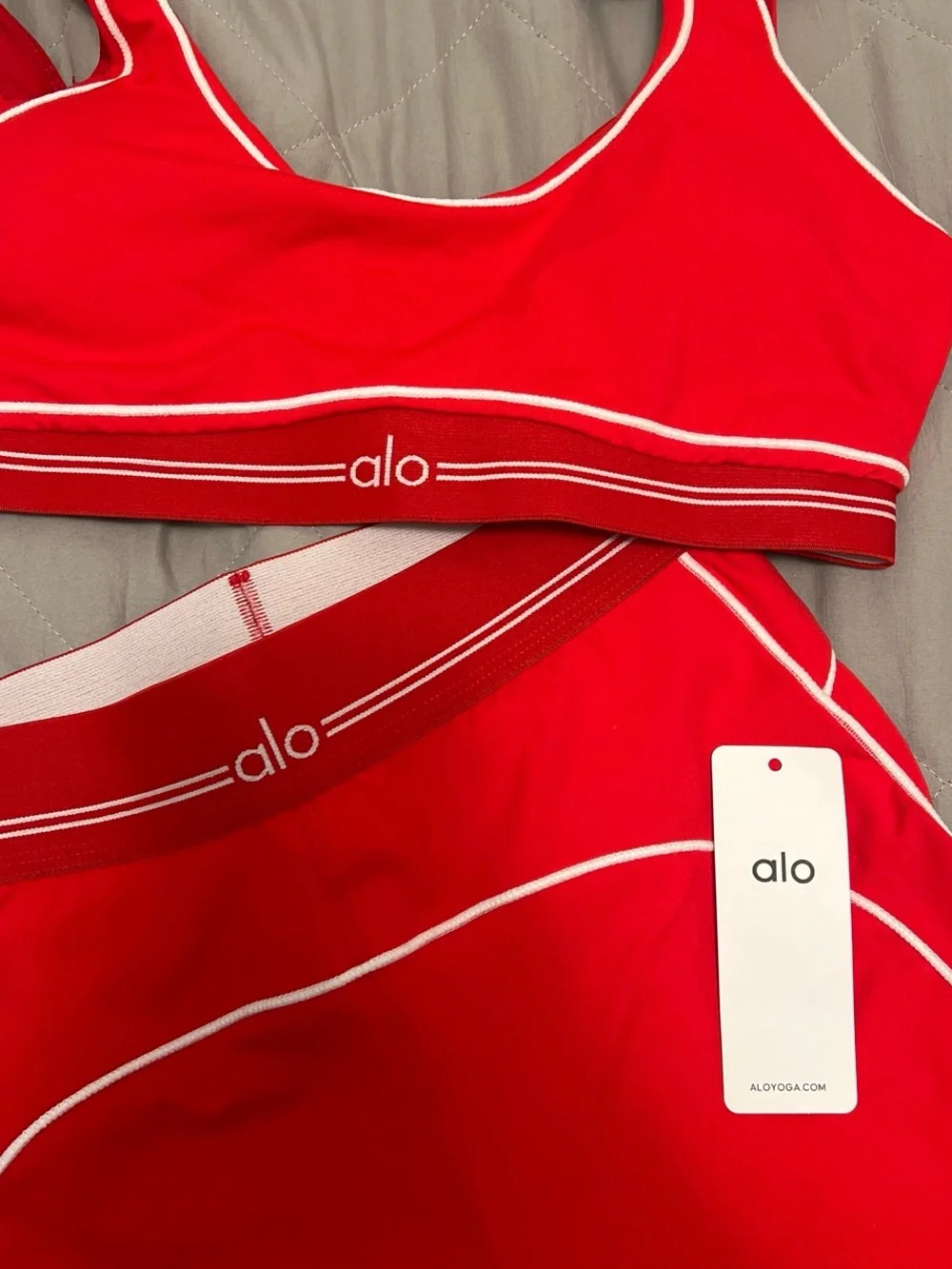 ALO Yoga red sports bra and leggings set with white piping